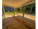View of an unfinished covered patio with support columns and green backyard at 1905 Old Bramble Ln # 4, Fuquay Varina, NC 27526