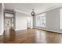 Bright living room with hardwood floors, crown molding, and large windows at 200 Single Tree Cir, Haw River, NC 27258