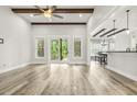 Open living area with wood beams, recessed lighting, and sliding glass doors leading to an outdoor deck at 212 Lynch Ave, Lillington, NC 27546