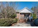 Inviting brick home featuring a quaint front porch and manicured shrubs at 2203 Eider Ct # A, Graham, NC 27253