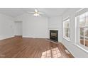 Bright living room with fireplace, ceiling fan, and natural light at 224 Hartshorn Ct, Holly Springs, NC 27540