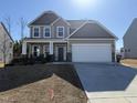 Charming two-story home featuring a covered front porch, two-car garage and long driveway at 257 Cliffview Dr, Garner, NC 27529