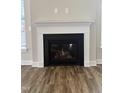 Cozy fireplace featuring a modern design with logs inside, as well as vinyl floors at 257 Cliffview Dr, Garner, NC 27529