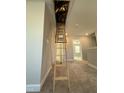 View of a hallway leading to a bedroom with wooden attic ladder at 257 Cliffview Dr, Garner, NC 27529