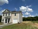 Attractive two-story home with vinyl siding, an attached garage, and a well-kept yard at 260 Johnson Ridge Way, Four Oaks, NC 27524