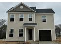 Charming two-story home with a large garage and neutral-colored siding, perfect for a Gathering at 260 Johnson Ridge Way, Four Oaks, NC 27524