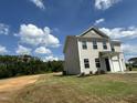 Inviting two-story home with vinyl siding, attached garage, surrounded by a lush green lawn at 260 Johnson Ridge Way, Four Oaks, NC 27524