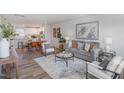 Open concept living area with a view of the dining room and kitchen, perfect for modern living at 260 Johnson Ridge Way, Four Oaks, NC 27524