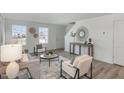 Bright living room featuring neutral tones, elegant decor, and windows for natural light at 260 Johnson Ridge Way, Four Oaks, NC 27524