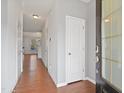 Bright hallway with hardwood floors leading to the main living areas of the home at 2901 Benevolence Dr, Raleigh, NC 27610