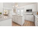 Open concept white kitchen with granite countertops, stainless appliances, and modern lighting at 316 Russ Rd, Smithfield, NC 27577