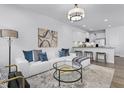 Cozy living room with a modern sofa, stylish decor, and seamless flow into the kitchen area at 324 Church St # 41, Wendell, NC 27591