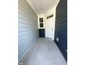 Inviting covered porch with a gray concrete floor and stylish blue siding at 328 Church St # 43, Wendell, NC 27591