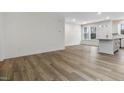 Spacious living room with wood-look floors offering an open floor plan to the kitchen and dining area at 330 Church St # 44, Wendell, NC 27591