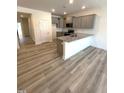 Open kitchen with gray cabinets, granite countertops and hardwood floors at 332 Church St # 45, Wendell, NC 27591