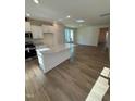 Bright, open kitchen with white cabinets, a large island, and modern appliances at 334 Church St # 46, Wendell, NC 27591