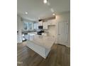 Clean, modern kitchen featuring white cabinetry, a stylish island, and stainless steel appliances at 334 Church St # 46, Wendell, NC 27591