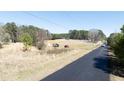 View of the land showing the road, trees, utility poles, and an area for construction at 4622 Durham Rd, Wake Forest, NC 27587