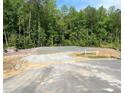 This property features a prepared building foundation, set amongst a stand of mature trees, perfect for building your dream home at 507 Olivia Crossing Ct # 20, Four Oaks, NC 27524
