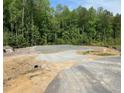 This property features a prepared building foundation, set amongst a stand of mature trees, perfect for building your dream home at 507 Olivia Crossing Ct # 20, Four Oaks, NC 27524