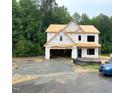 Two-story home's exterior framing is shown during construction; garage and roofing visible at 507 Olivia Crossing Ct # 20, Four Oaks, NC 27524