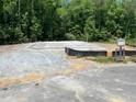 Poured foundation on a wooded lot, ready for new construction, providing a serene setting at 507 Olivia Crossing Ct # 20, Four Oaks, NC 27524
