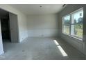 Bright living room with wall paneling detail to the wall and a large window under construction at 507 Olivia Crossing Ct # 20, Four Oaks, NC 27524
