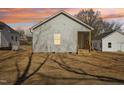 Rear exterior of the home showcasing the yard and back entrance at 614 Gilmer St, Burlington, NC 27217
