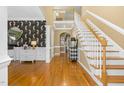 Elegant foyer with hardwood floors, staircase, and stylish wallpaper at 6489 Waters Edge Dr, Rocky Mount, NC 27803