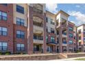 Attractive red brick apartment building with black wrought iron balconies and manicured landscaping at 700 Finsbury St # 304, Durham, NC 27703