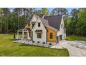 Stylish two-story home with a modern design, showcasing a well-maintained lawn and an attached garage at 80 Carnation Rd, Youngsville, NC 27596