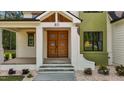 Close-up of the front entrance with a modern wood door and stylish white brick pillars at 80 Carnation Rd, Youngsville, NC 27596