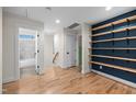 Bright hallway with custom shelving and an open doorway to a tiled bathroom at 917 S Blount St, Raleigh, NC 27601