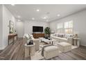 Spacious living room featuring hardwood floors, plush seating, and modern decor at 1018 Freestone Rd, Durham, NC 27703