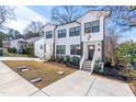 New townhome with a well-manicured lawn, a front walkway, and a white siding facade at 1211 N Guthrie Ave, Durham, NC 27703