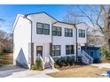 Picture of a new white townhouse featuring a porch entry and manicured landscaping in front at 1211 N Guthrie Ave, Durham, NC 27703