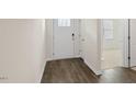 A welcoming entryway features wood-look flooring and a view into a carpeted living space at 1749 Post Oak Dr, Haw River, NC 27258