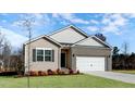Inviting single-Gathering home featuring a brick-accented facade, a two-car garage, and a green lawn at 1749 Post Oak Dr, Haw River, NC 27258