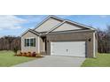 Beautiful single-story home with a two-car garage and manicured lawn, offering curb appeal and convenience at 1749 Post Oak Dr, Haw River, NC 27258