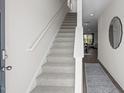 Inviting entryway featuring carpeted stairs and an open view to the living area at 1914 Frost Dr, Haw River, NC 27258