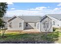 View of the back of the house with a patio, lawn, and several windows at 2030 Fawn Meadow Way, Fuquay Varina, NC 27526