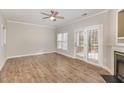 Spacious living room with hardwood floors, ceiling fan, and a view to an outdoor patio at 2623 Broad Oaks Pl, Raleigh, NC 27603