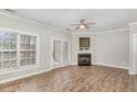 Bright living room with hardwood floors, a ceiling fan, and a cozy fireplace at 2623 Broad Oaks Pl, Raleigh, NC 27603