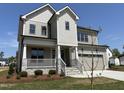 Attractive two-story home showcasing a stone-accented porch, a two-car garage, and a well-maintained yard at 3521 Amelia Grace Dr # 67, Fuquay Varina, NC 27526
