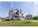Beautiful two-story home featuring a covered front porch and attached two-car garage at 3521 Amelia Grace Dr # 67, Fuquay Varina, NC 27526