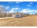 Beautiful home with a large yard, long driveway, and classic farmhouse design details set on spacious lot at 3608 Buzzard Rd, Wendell, NC 27591