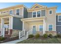 Charming townhome featuring a light yellow exterior with a welcoming covered front porch at 3725 Rosebush Dr, Zebulon, NC 27597