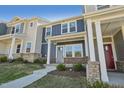 Charming two-story townhome with brick accents and inviting covered front porch at 3727 Rosebush Dr, Zebulon, NC 27597