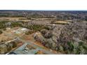 Panoramic aerial view of a property featuring wooded areas and accessible roads at 3817 Nc-119, Mebane, NC 27302