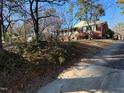 Quaint brick home with a welcoming entrance and lovely landscaping on a sunny day at 402 Willow St, Cary, NC 27511